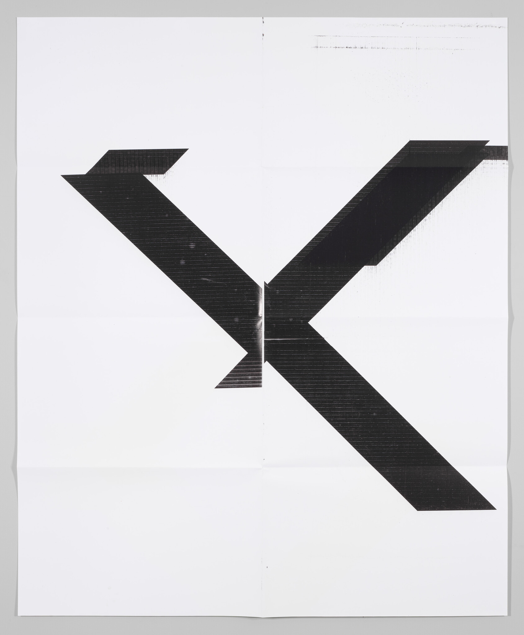 Large bold black geometric X shape printed on a white folded poster.