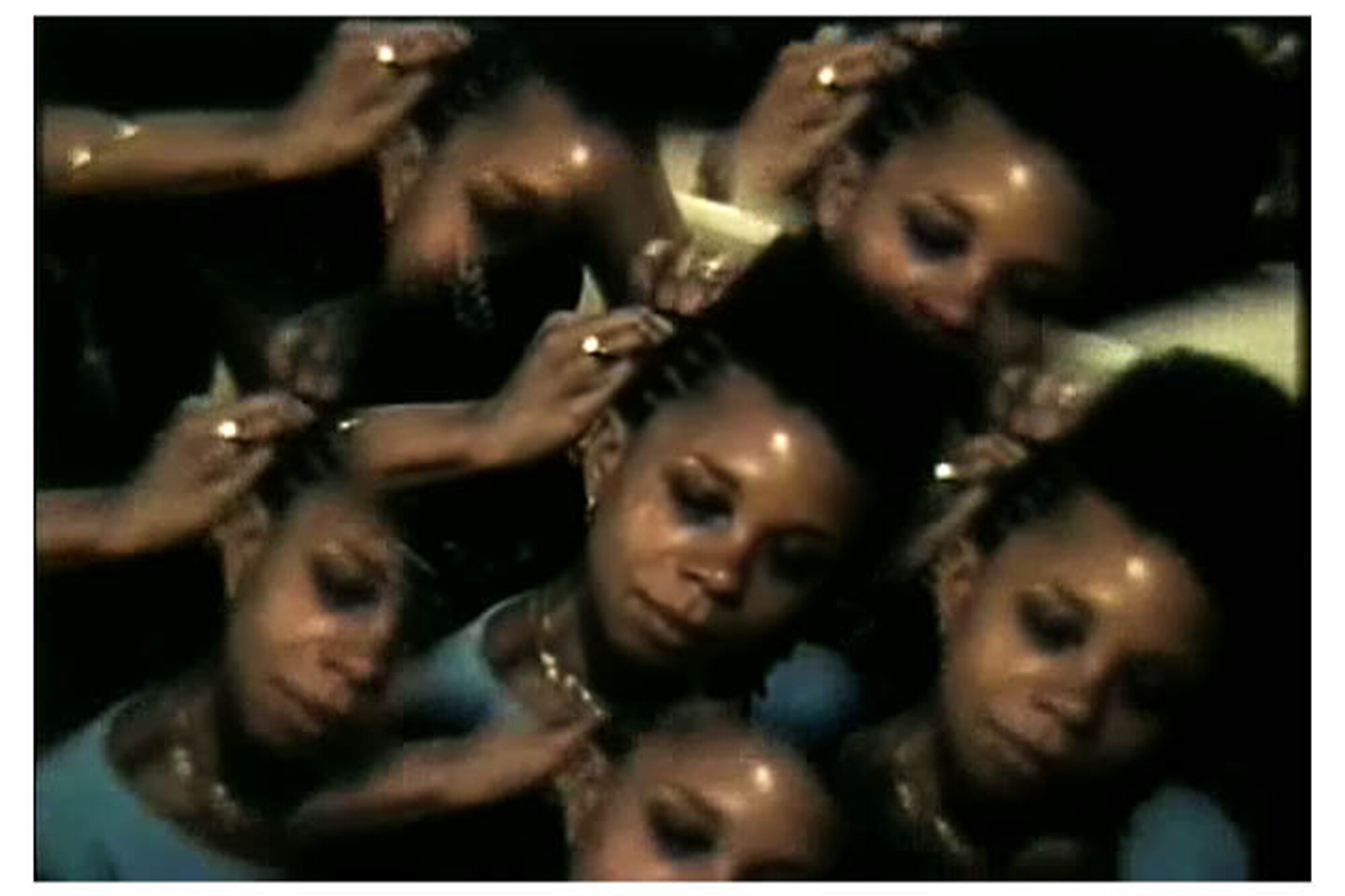 A kaleidoscopic effect showing multiple, slightly transparent images of a woman with her hand near her face, creating a dreamy, repetitive visual pattern. The image has a dark background and the woman is wearing a blue top.