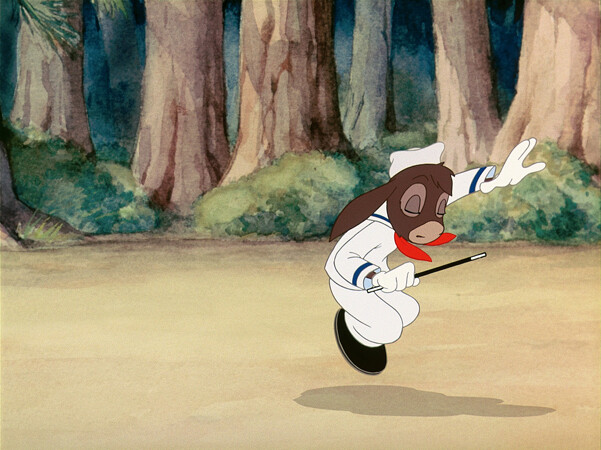 A brown rabbit in a white sailor suit leaps while waving a conductor's baton in a forest clearing.