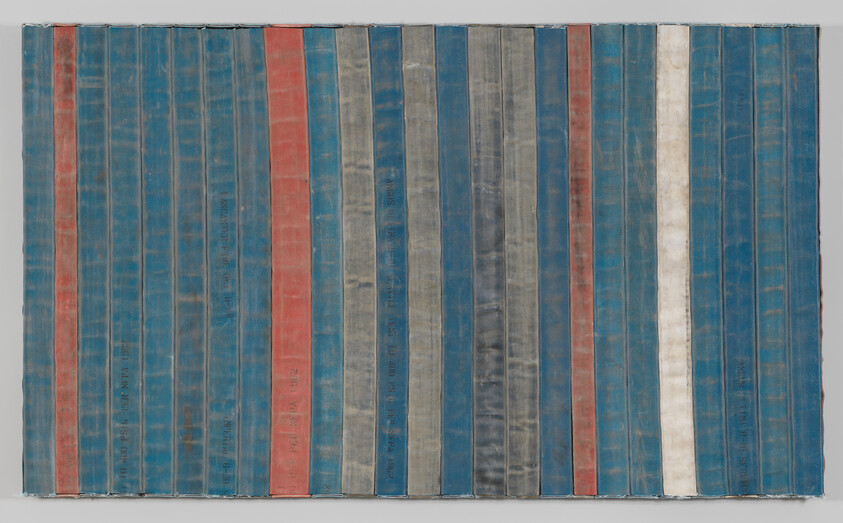 A series of fire hoses arranged vertically, painted in various shades of blue, green, orange, and white