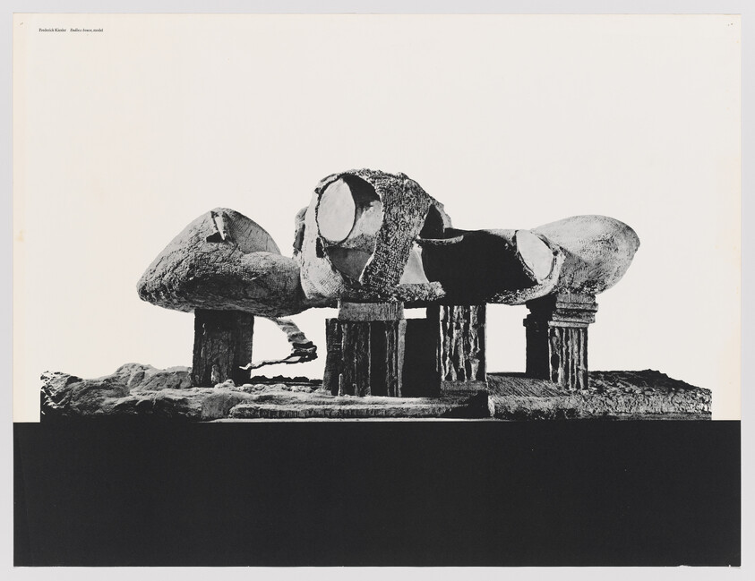 A large abstract sculpture with bulbous shell forms supported by column-like pillars on a base.