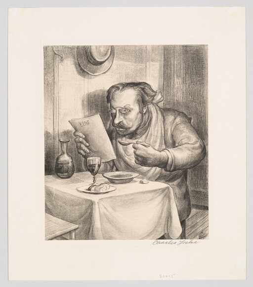 A man at a small table reads a wine list while holding a spoon and glass.