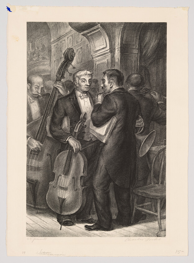 A conductor speaks to a cellist holding his instrument while other orchestra members wait.
