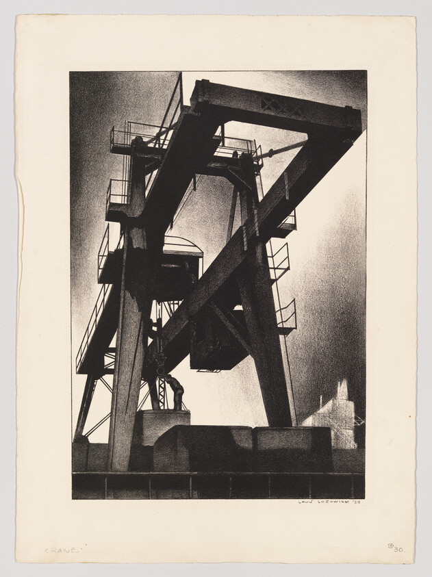 Tall industrial gantry crane towers over dock with a worker standing beneath it.