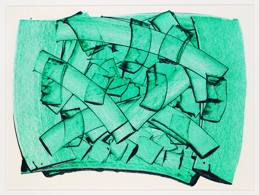 A collection of broken glass pieces with sharp edges, tinted in a vibrant green color, scattered across a flat surface. The background is a lighter shade of green, providing contrast to the glass fragments. The entire composition is framed against a white backdrop.
