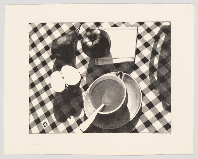 A cup and saucer with a spoon surrounded by apples and a pear on a checkered tablecloth.
