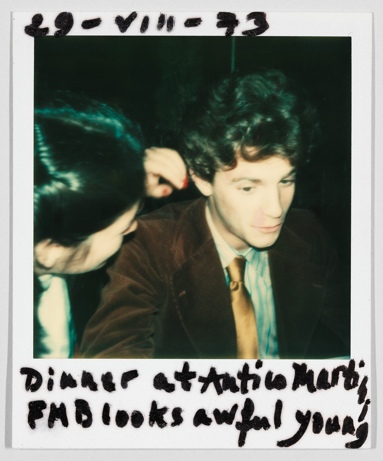 Two people sit close together at a dinner table; handwritten text says, "Dinner at Antica Marti, FMB looks awful young."