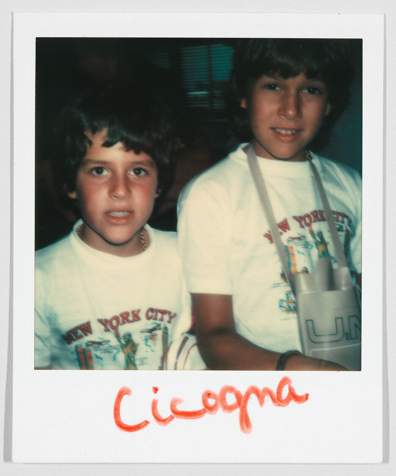 Two children wearing matching "New York City" t-shirts, with "Cicogna" written in red at the bottom.