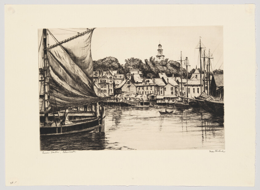 A sailing ship with raised sail docked in a calm harbor before a small seaside town.