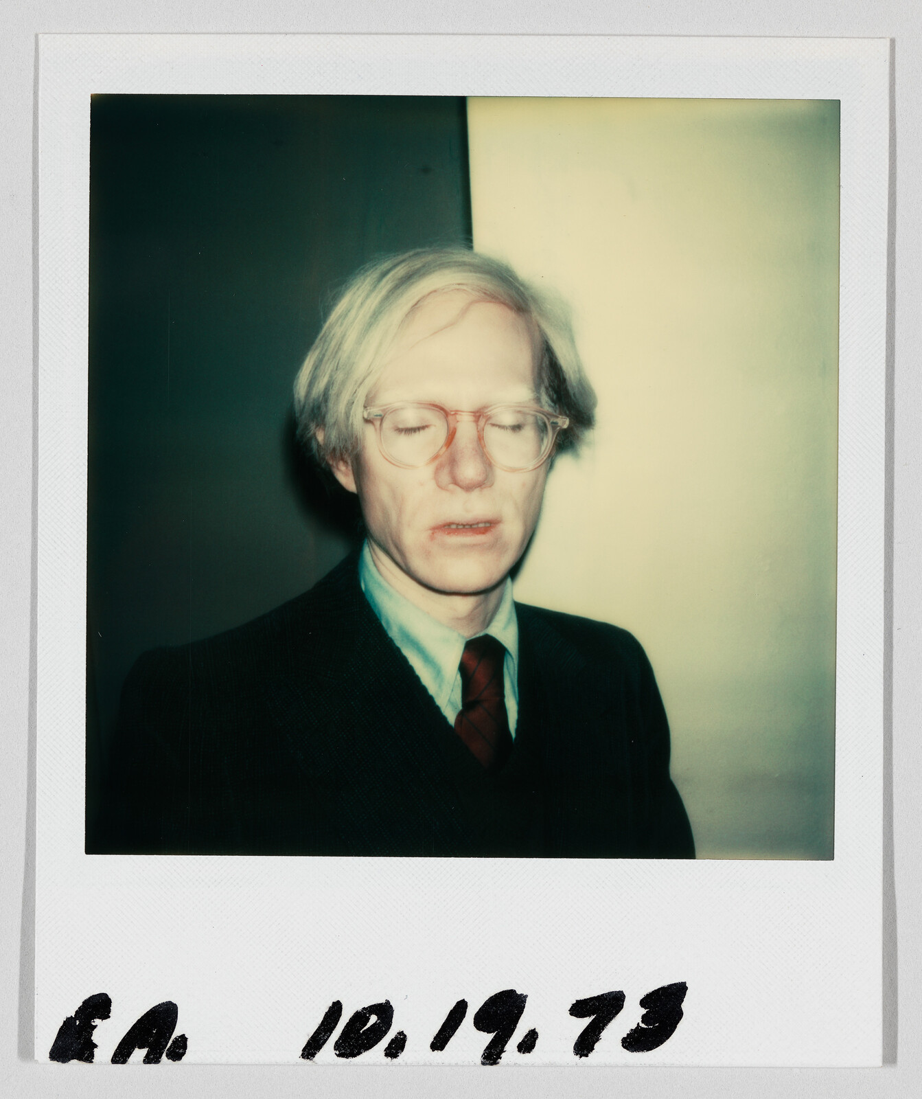 A man with light hair and glasses stands with his eyes closed. Handwritten date reads 10.19.73.