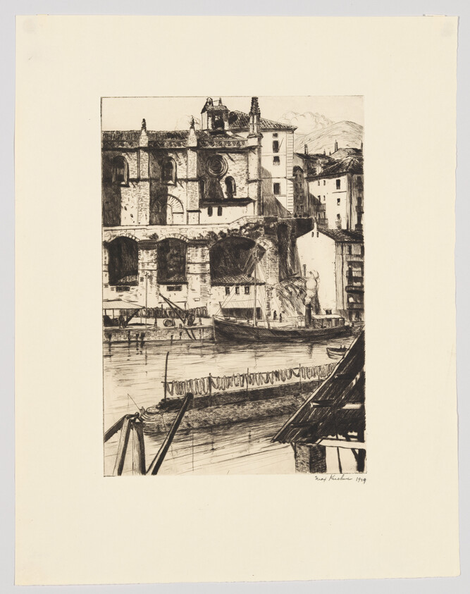 A riverside scene with moored sailboats and a large stone building with arched windows.