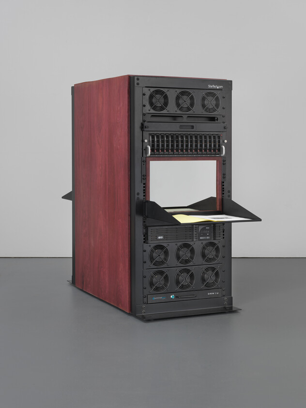 Tall server rack with wooden sides and open front shelf holding papers and a keyboard.