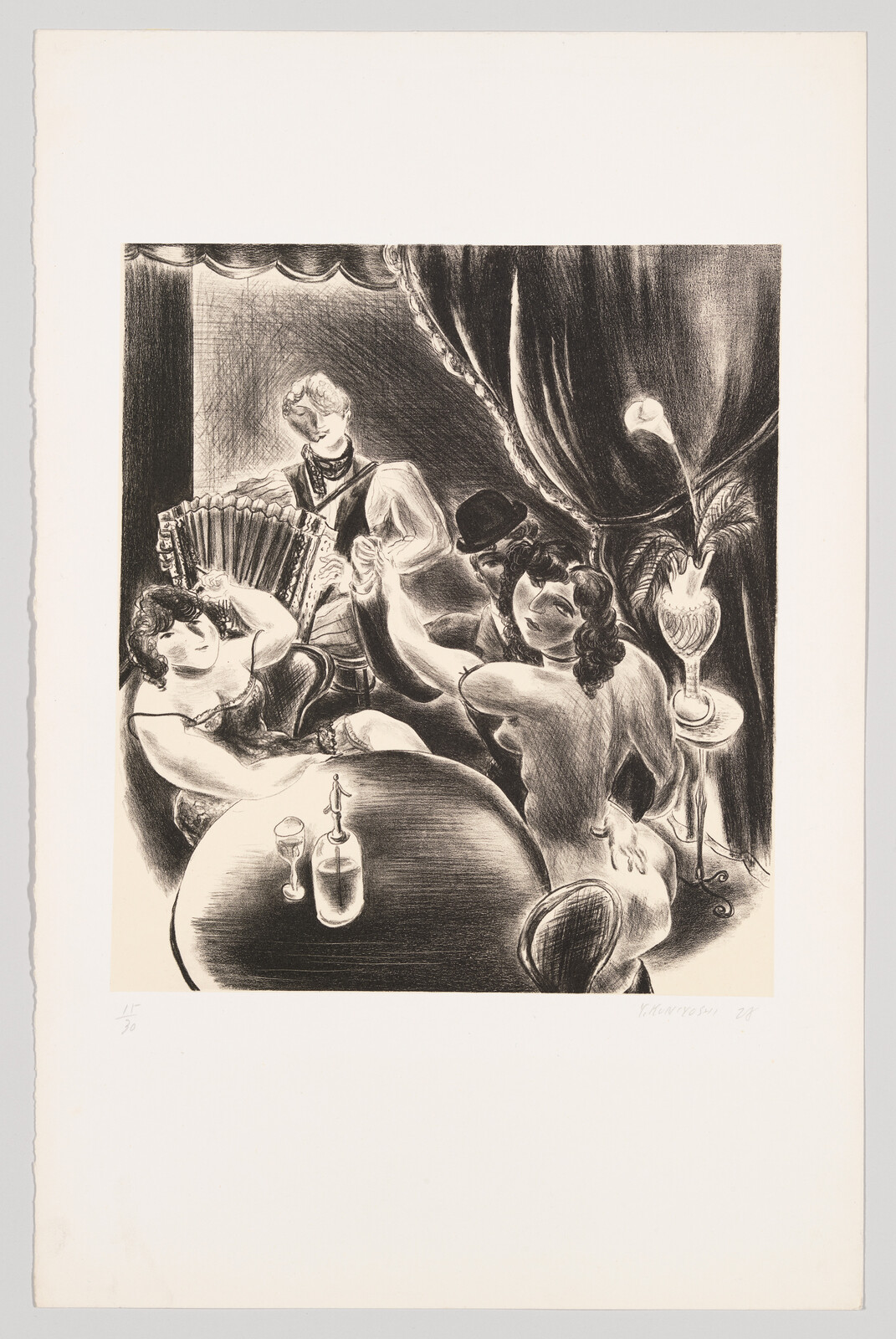 Two women and a man at a cabaret table while an accordion player performs nearby.