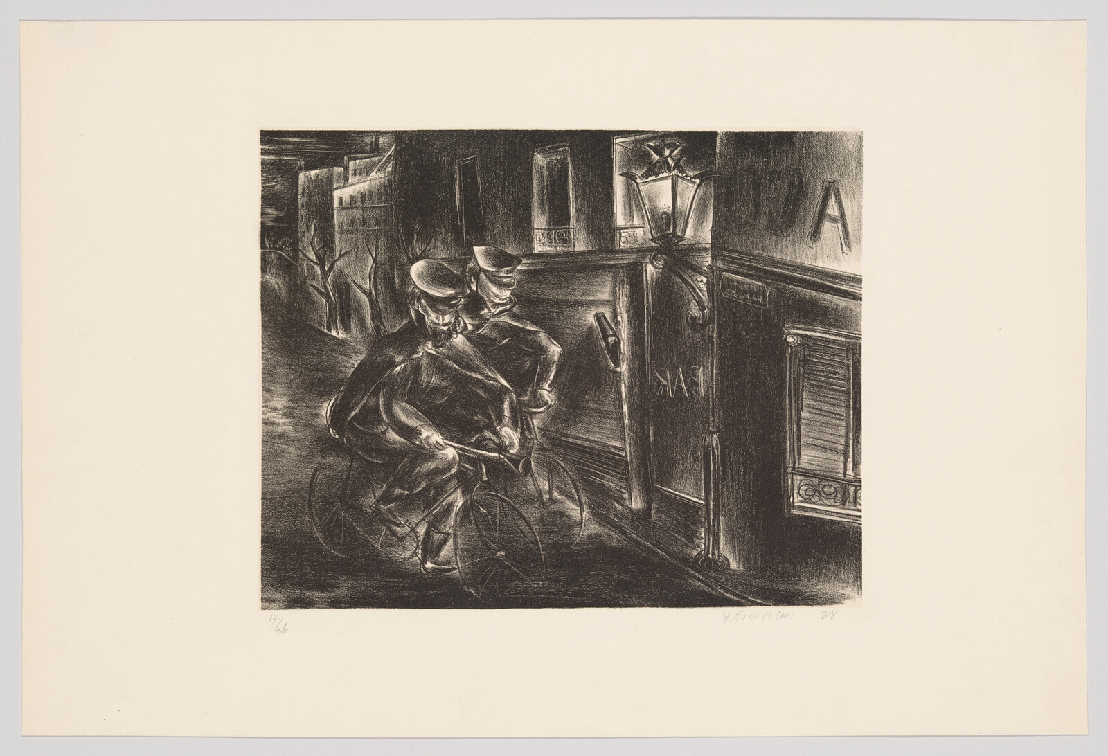 Two uniformed policemen ride bicycles at night past a gas-lit storefront.