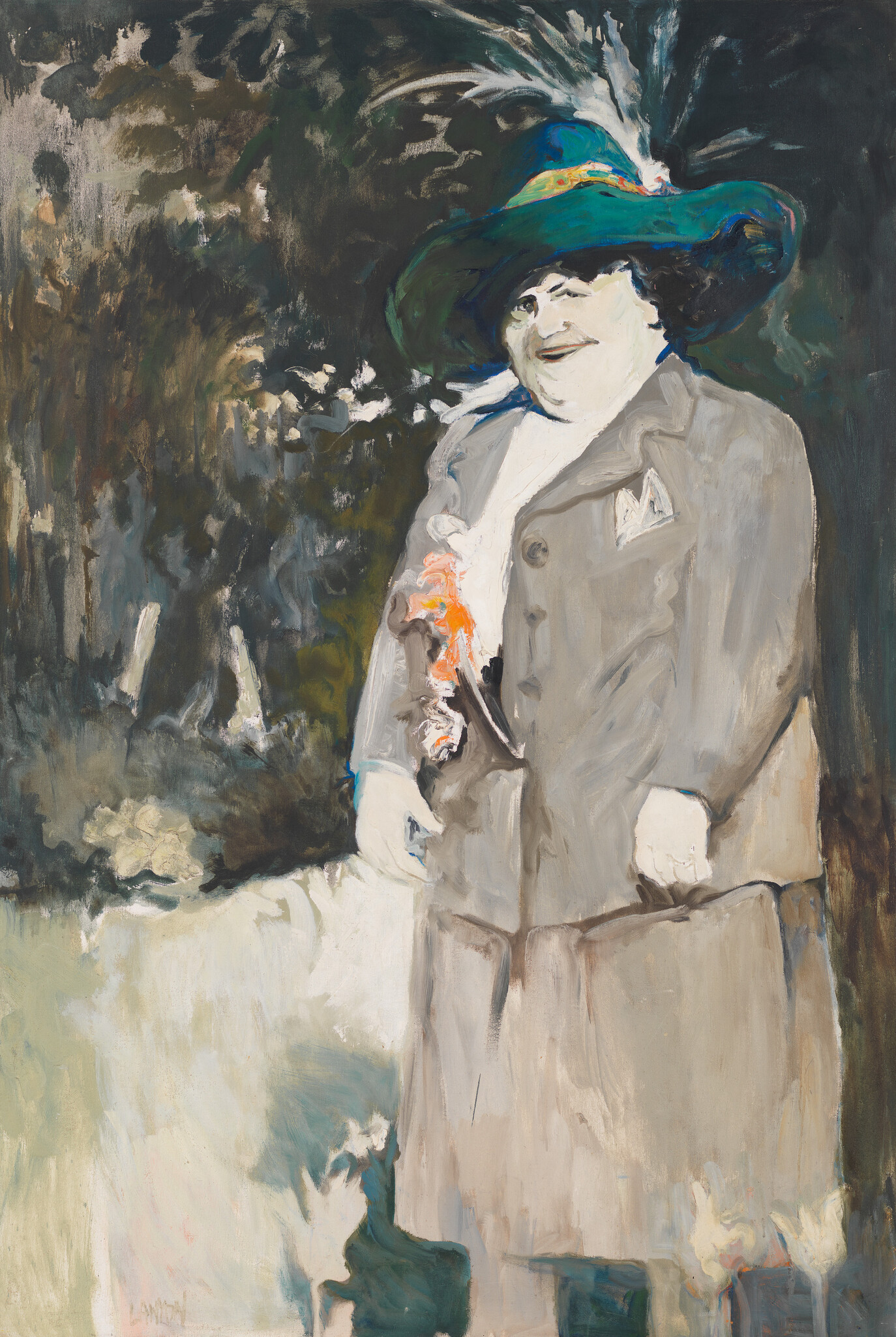 A smiling woman in a large green hat and gray coat holds a small bouquet of orange flowers.
