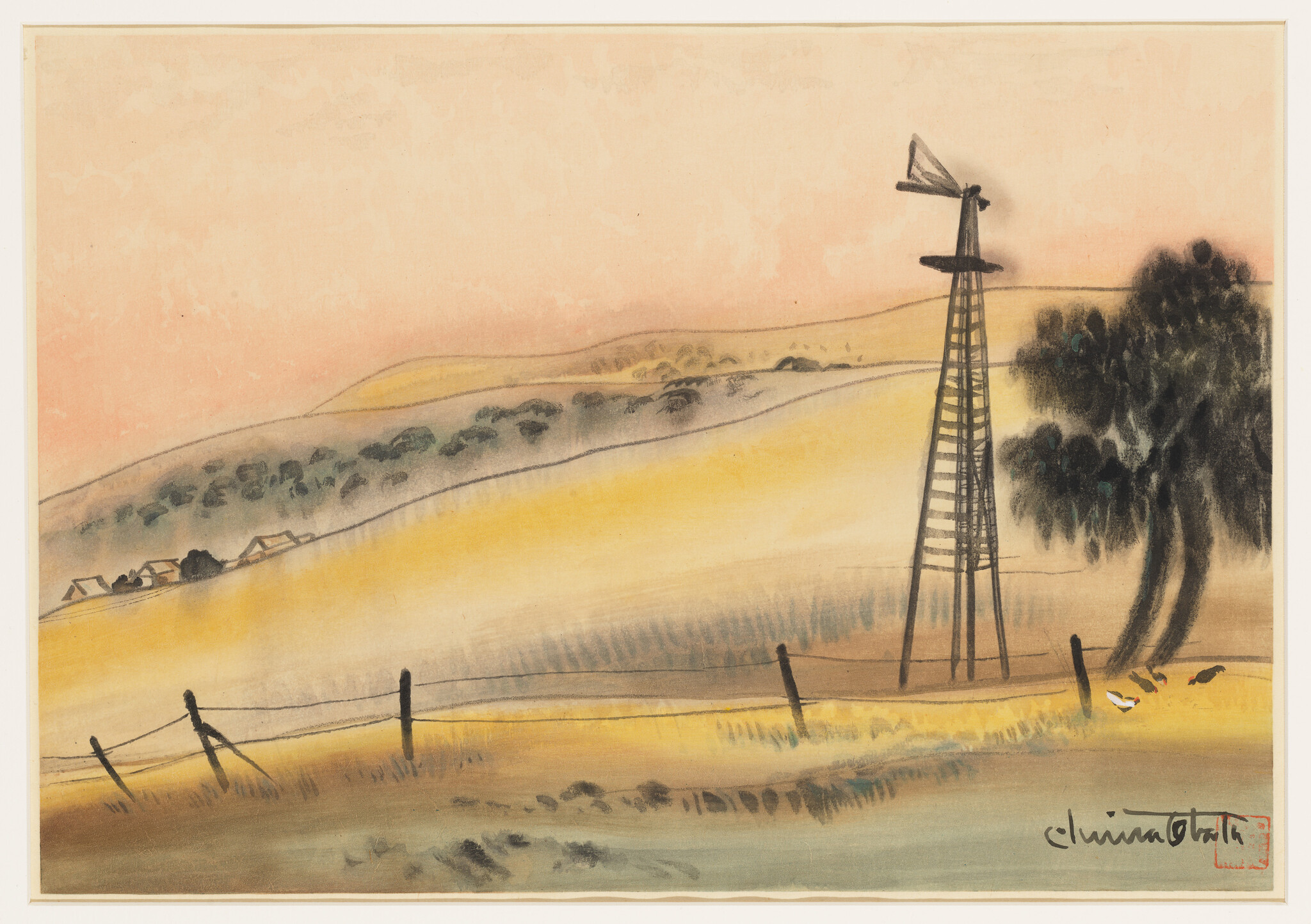 A tall wooden windmill stands beside a tree in golden rolling hills at sunset.