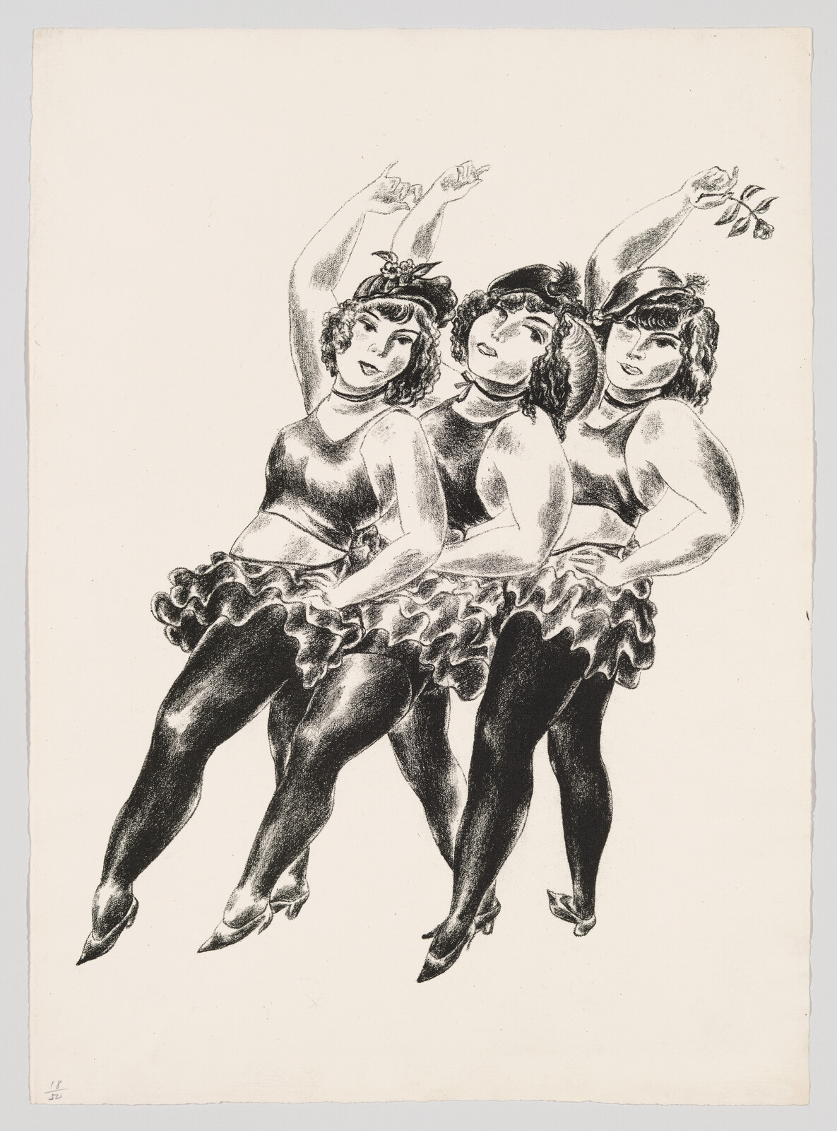 Three women dancers in matching costumes link arms and raise one arm while kicking legs.