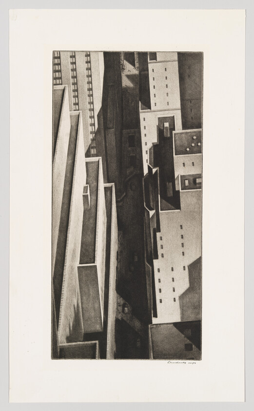 A vertical aerial view of geometric rooftops and narrow streets casting strong shadows between tall buildings.