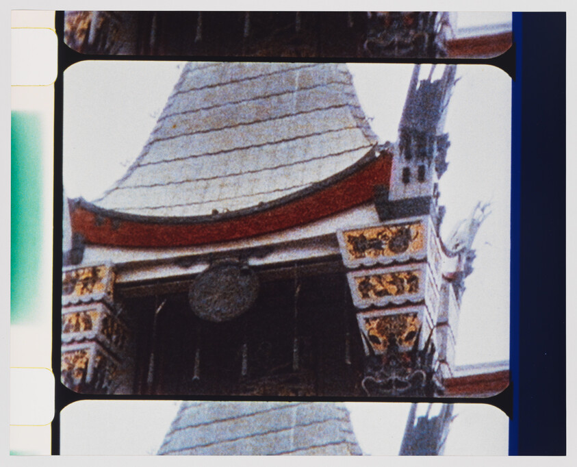 Ornate Asian-style temple roof with curved tiled eaves and decorative gold-painted carvings.