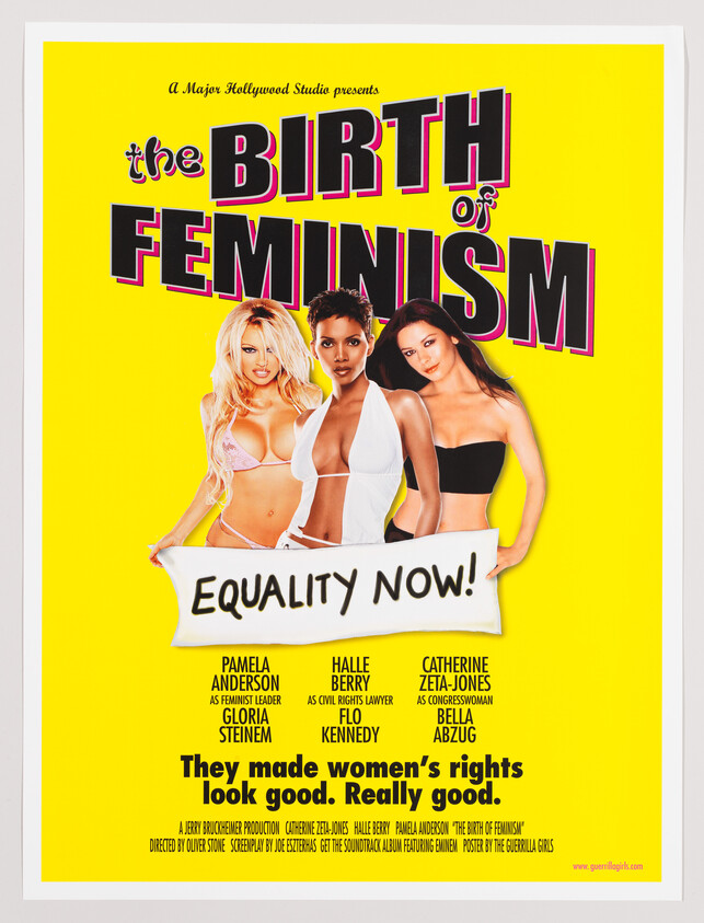 Three women in front of a bright yellow poster hold a banner that reads "Equality Now!".