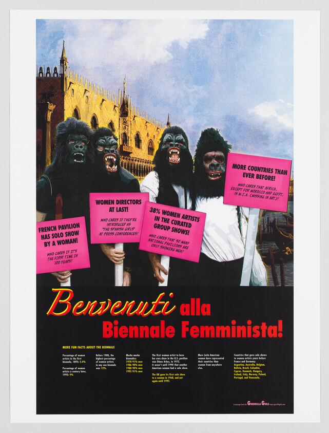 Four people in gorilla masks hold pink protest signs in front of Venetian architecture promoting a feminist biennale.
