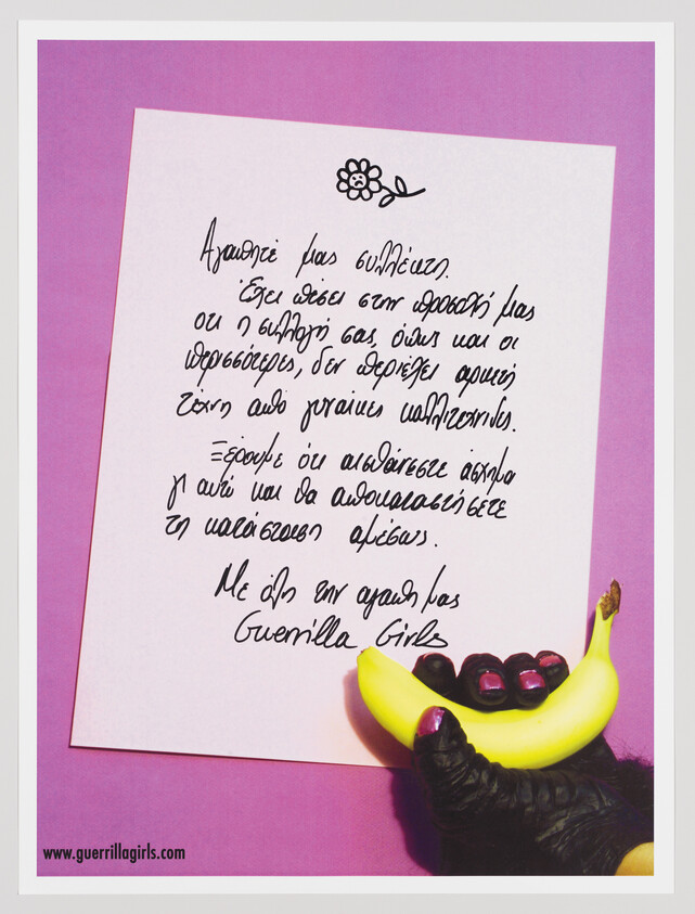 A gloved hand holding a banana next to a handwritten feminist note on pink paper.