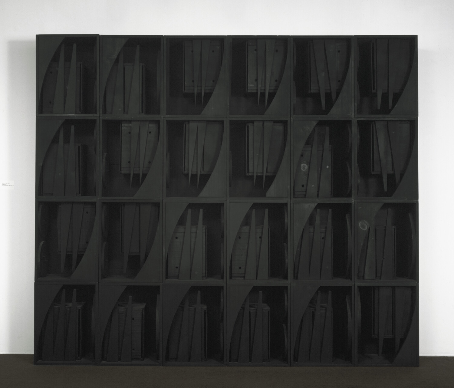 Large black shelving unit with 25 cubbies, each holding several vertical panels or folders.