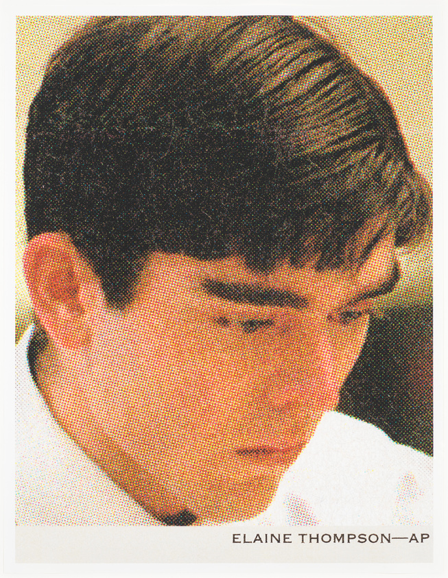 Young man with dark hair looking down, wearing a white shirt. The image has a halftone effect.