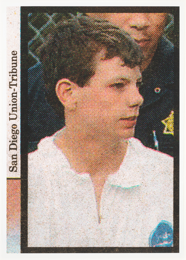 A young person in a white shirt stands in front of a fence, with a police officer partially visible behind them. "San Diego Union-Tribune" text on the side.