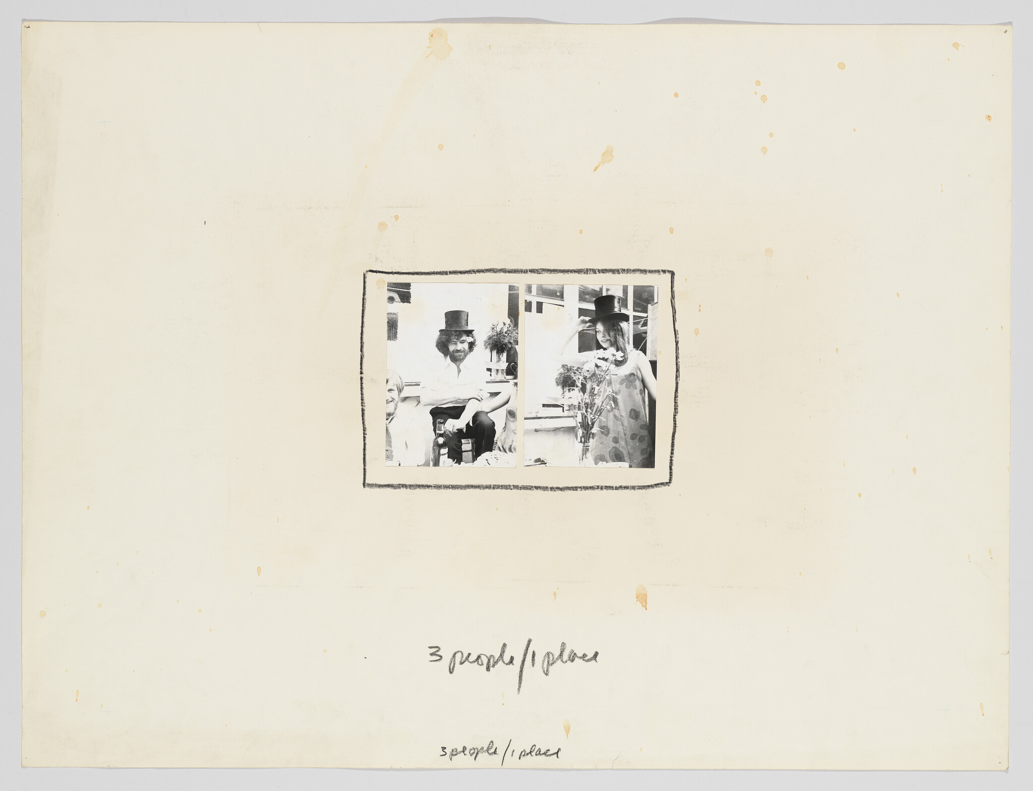 Two people wearing top hats pose beside a third person, one holding a bouquet.