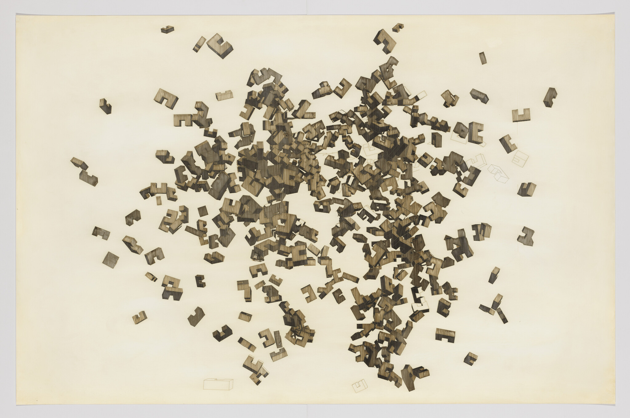 Many small dark geometric wooden puzzle pieces are scattered across a pale background.
