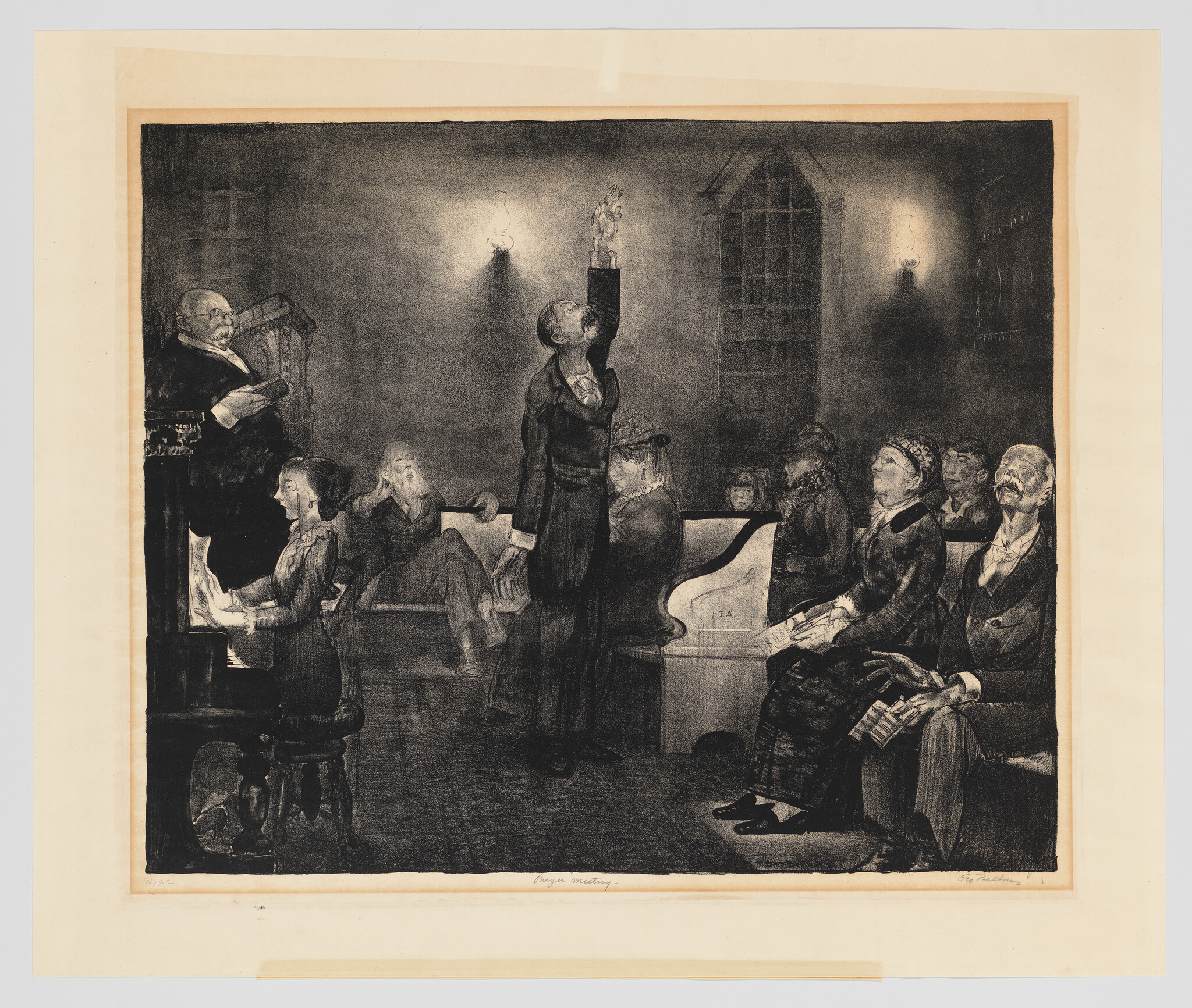 A man stands in a dim chapel raising his hand toward a small lamp while others sit.