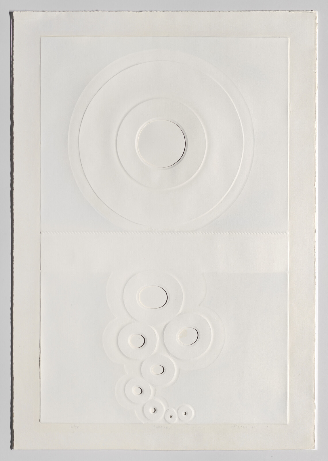 Embossed paper with a large concentric circle at top and a vertical cluster of smaller concentric circles below.