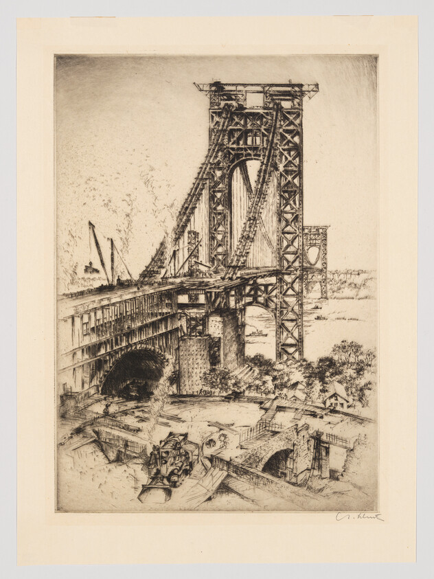 A large steel suspension bridge under construction with workers and scaffolding near the riverbank.