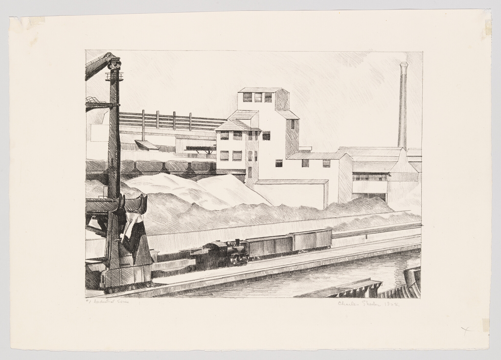 A small locomotive pulls freight cars past factories and large gravel piles beside a canal.