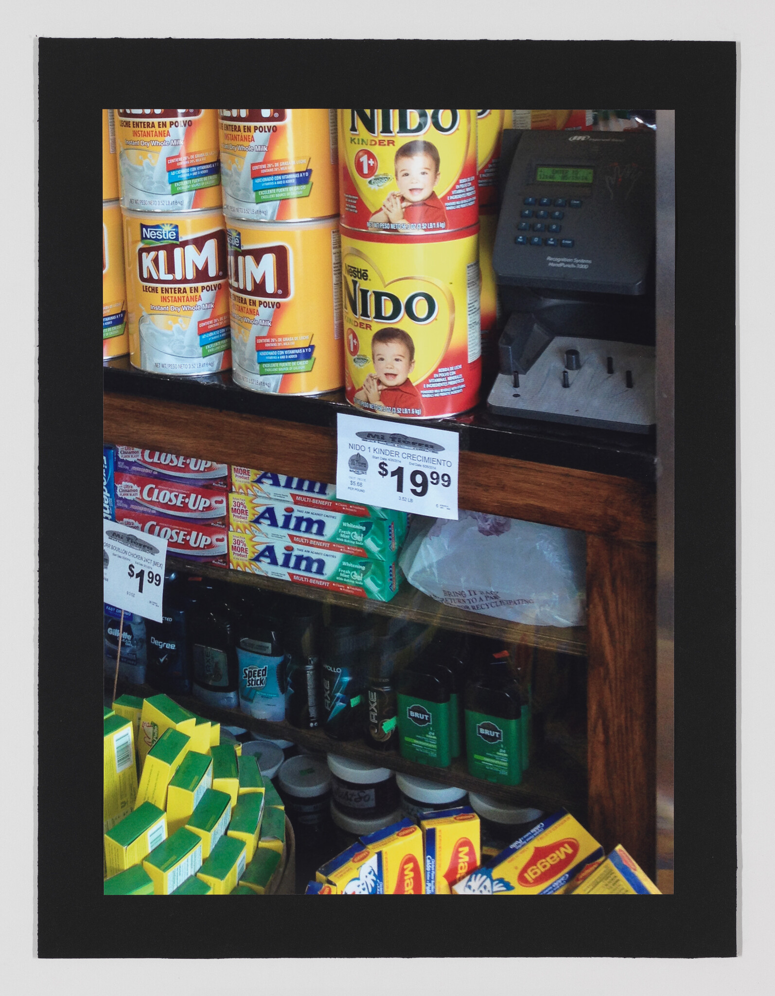 Cans of Nido and Klim powdered milk sit on a store shelf with a $19.99 price tag.