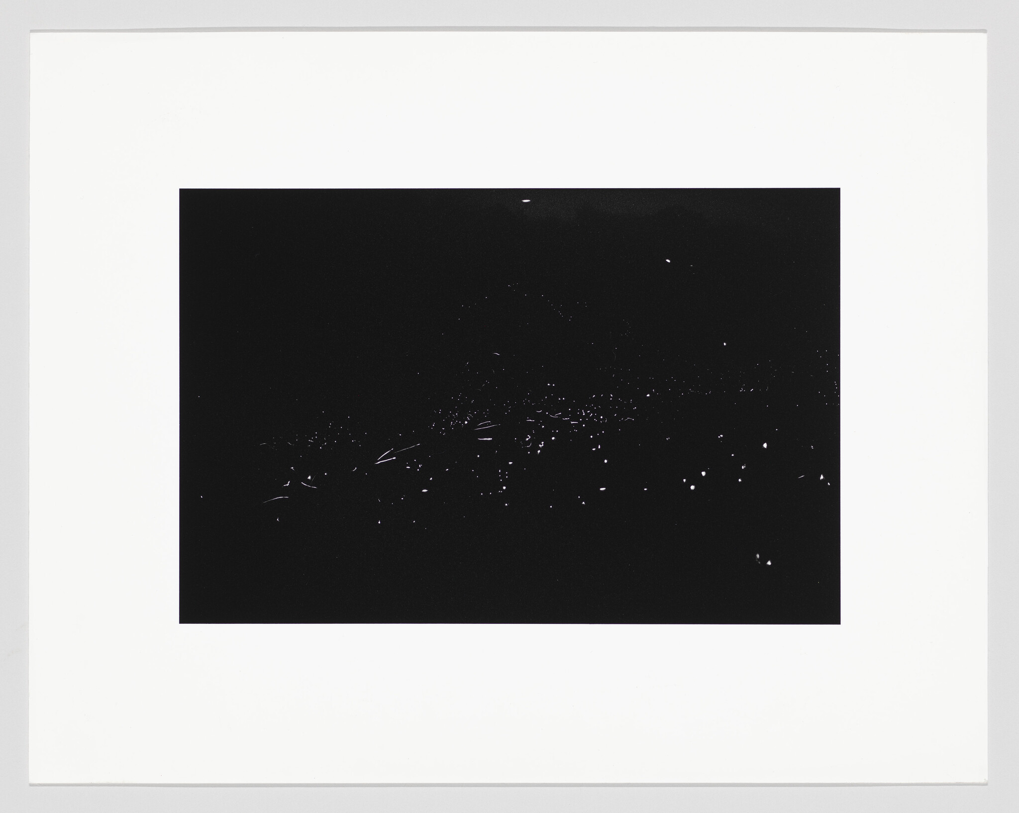 Dark rectangular print with scattered tiny white specks suggesting distant stars or lights.