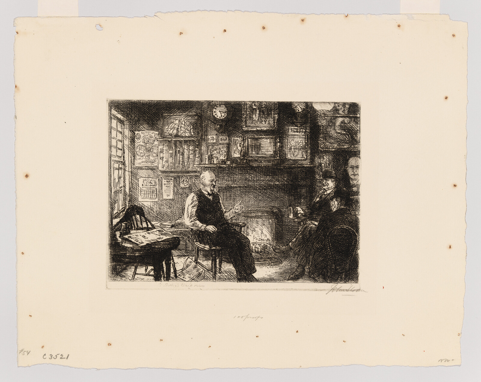 Two men sit by a fireplace in a cluttered room, talking while one holds a cup.