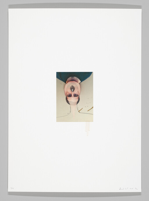 Upside-down portrait of a person with dark makeup and a small object attached to their nose.