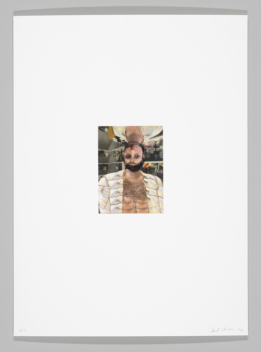 A small upside-down portrait of a bearded man with open shirt showing chest hair.