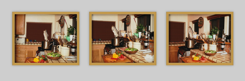 A cluttered kitchen counter with chopped vegetables, a pot on the stove, and utensils.
