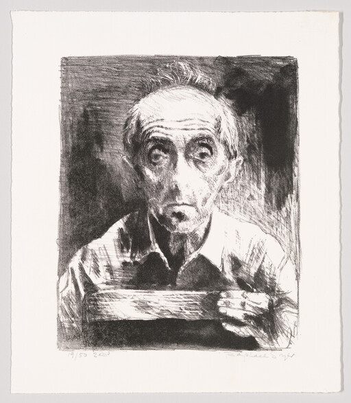 Elderly man with gaunt face holds a rectangular board while staring directly ahead.