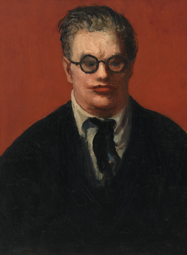 A man wearing round glasses and a dark suit stares forward against a plain red background.