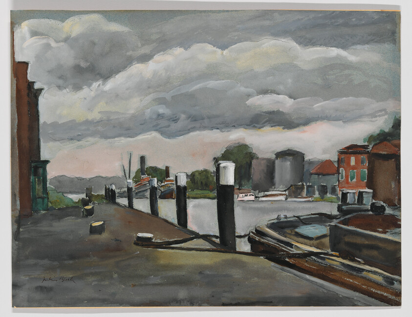 A quiet dock with moored boats, tall pilings, and buildings under heavy gray clouds.