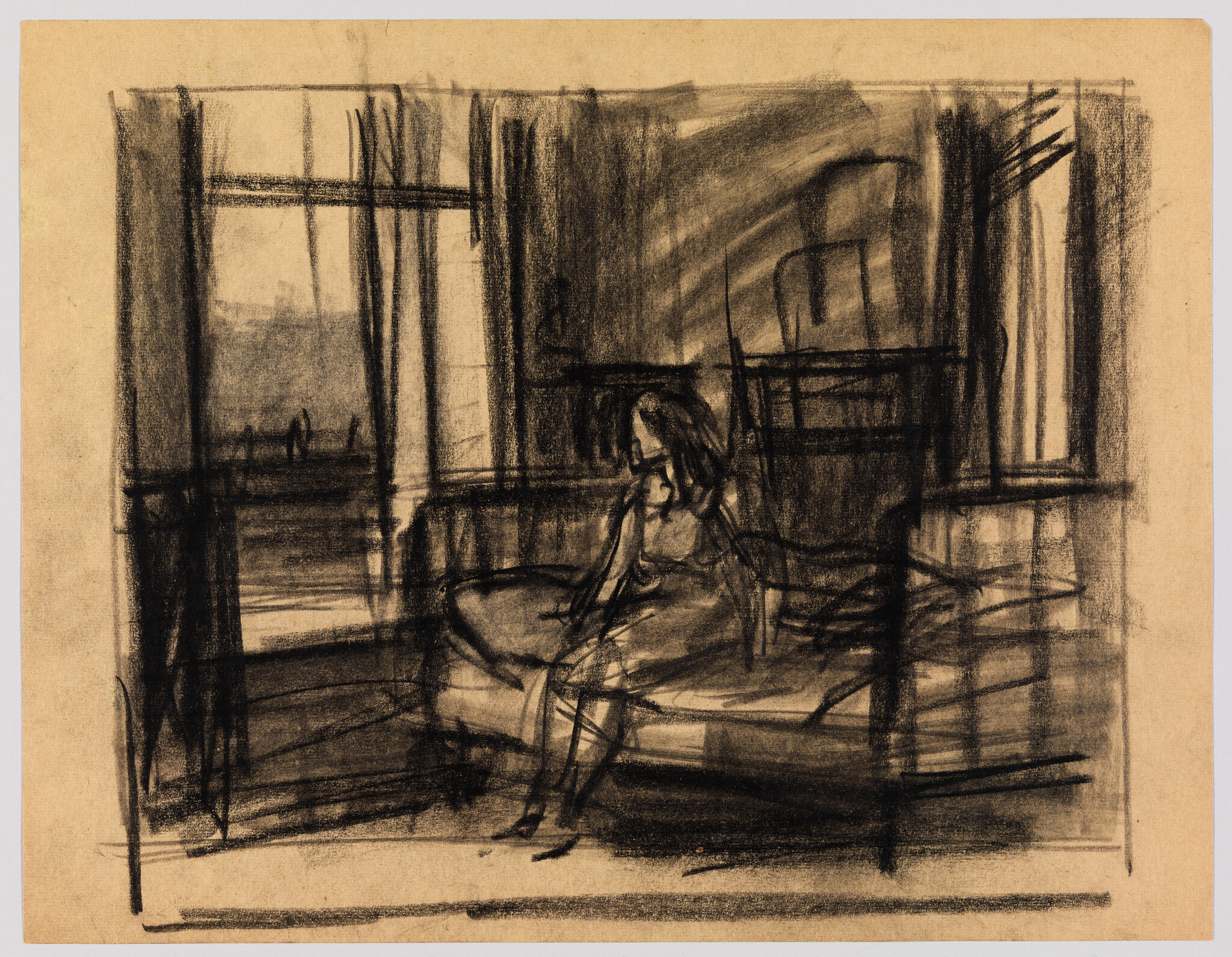 A woman sits on the edge of a bed near a window, looking down.