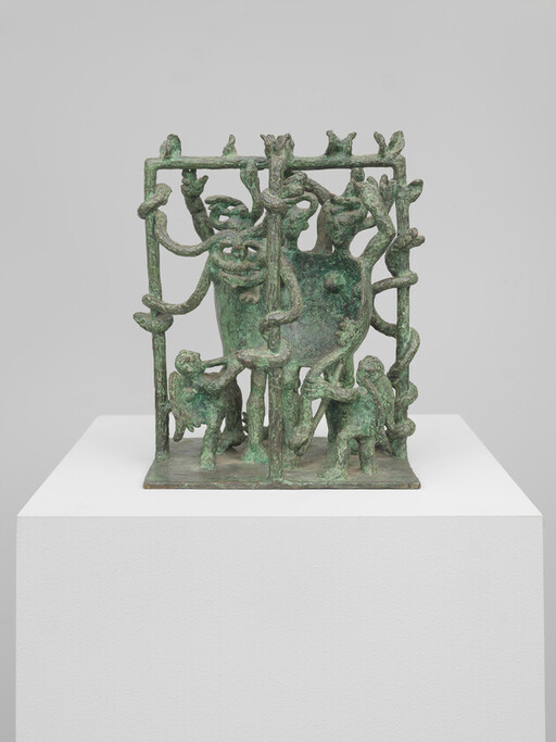 Bronze green patina sculpture of a horned creature enclosed by vines with three small figures climbing.