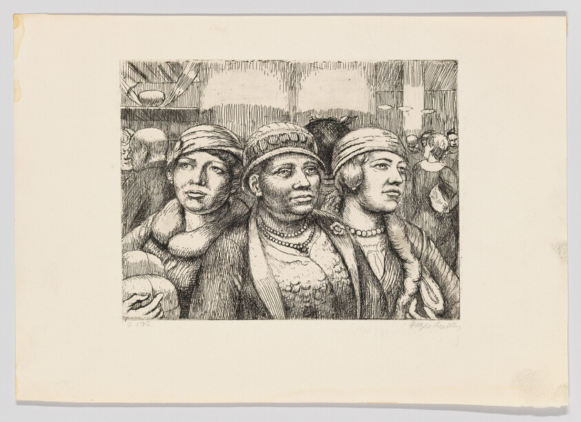 Three women in hats and necklaces stand closely together in a crowded interior scene.