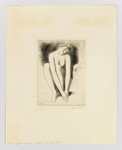 Nude woman seated on the floor leaning forward and touching her feet beside a chair.