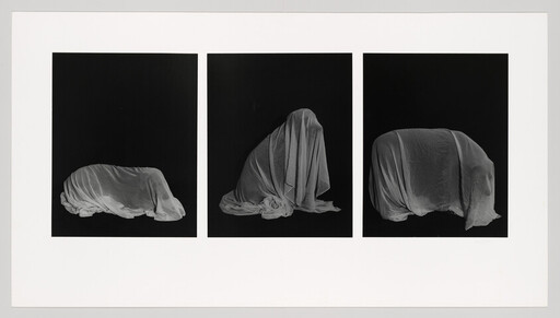 Three black panels show white cloth draped over three shrouded forms suggesting hidden figures.
