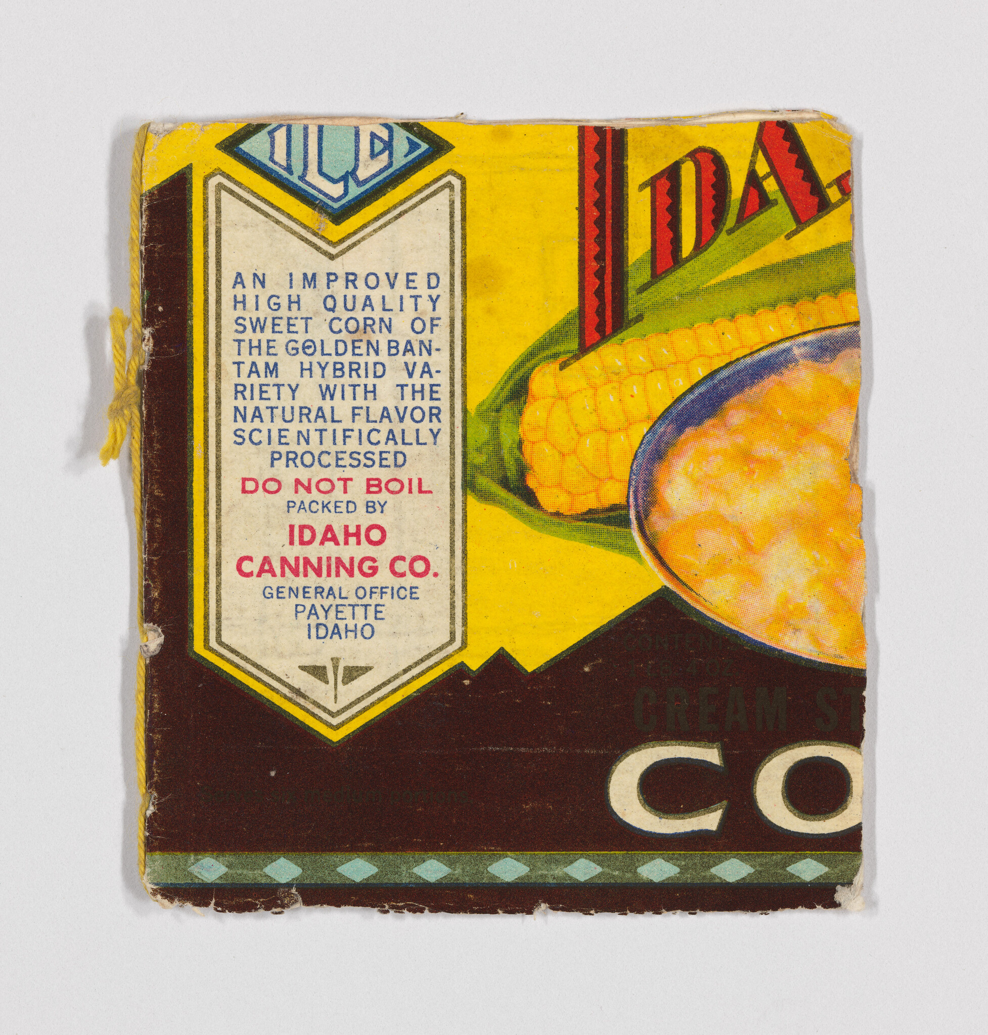 Vintage Idaho Canning Co. label showing ears of corn, a bowl of creamed corn, and the text "Do not boil."